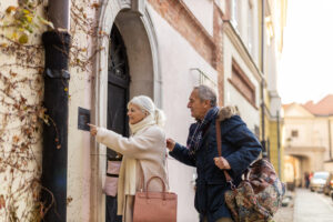 An image of happy elderly people enjoying their retirement visiting a hotel in a historical building